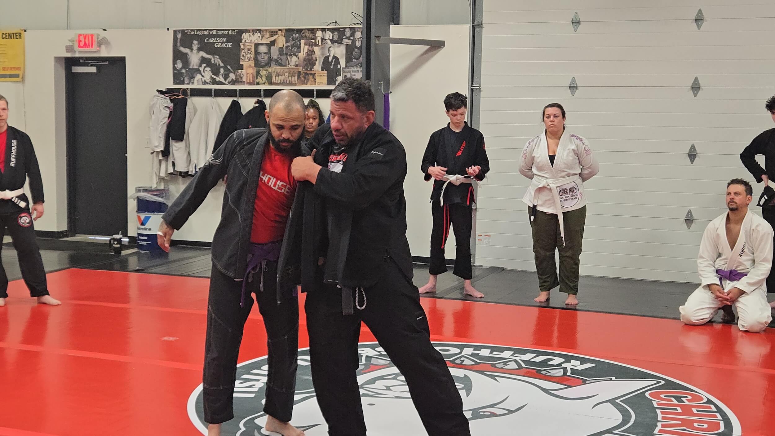 Ruffhouse Jiu-Jitsu instructor practicing BJJ techniques with student.