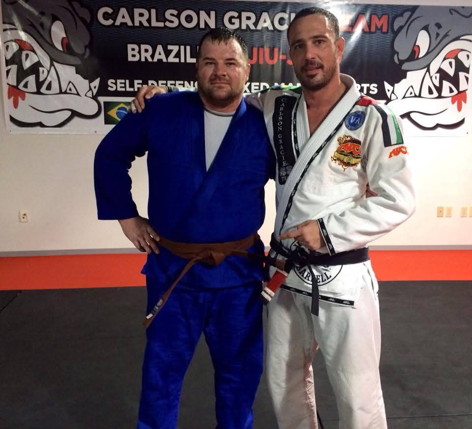 Ruffhouse Jiu-Jitsu students smiling together wearing gi uniforms.