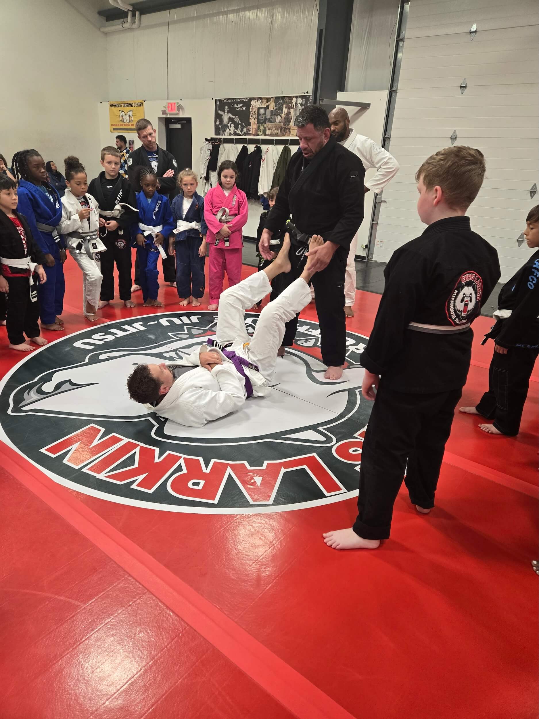 Ruffhouse Jiu-Jitsu instructor demonstrating proper BJJ techniques with students.