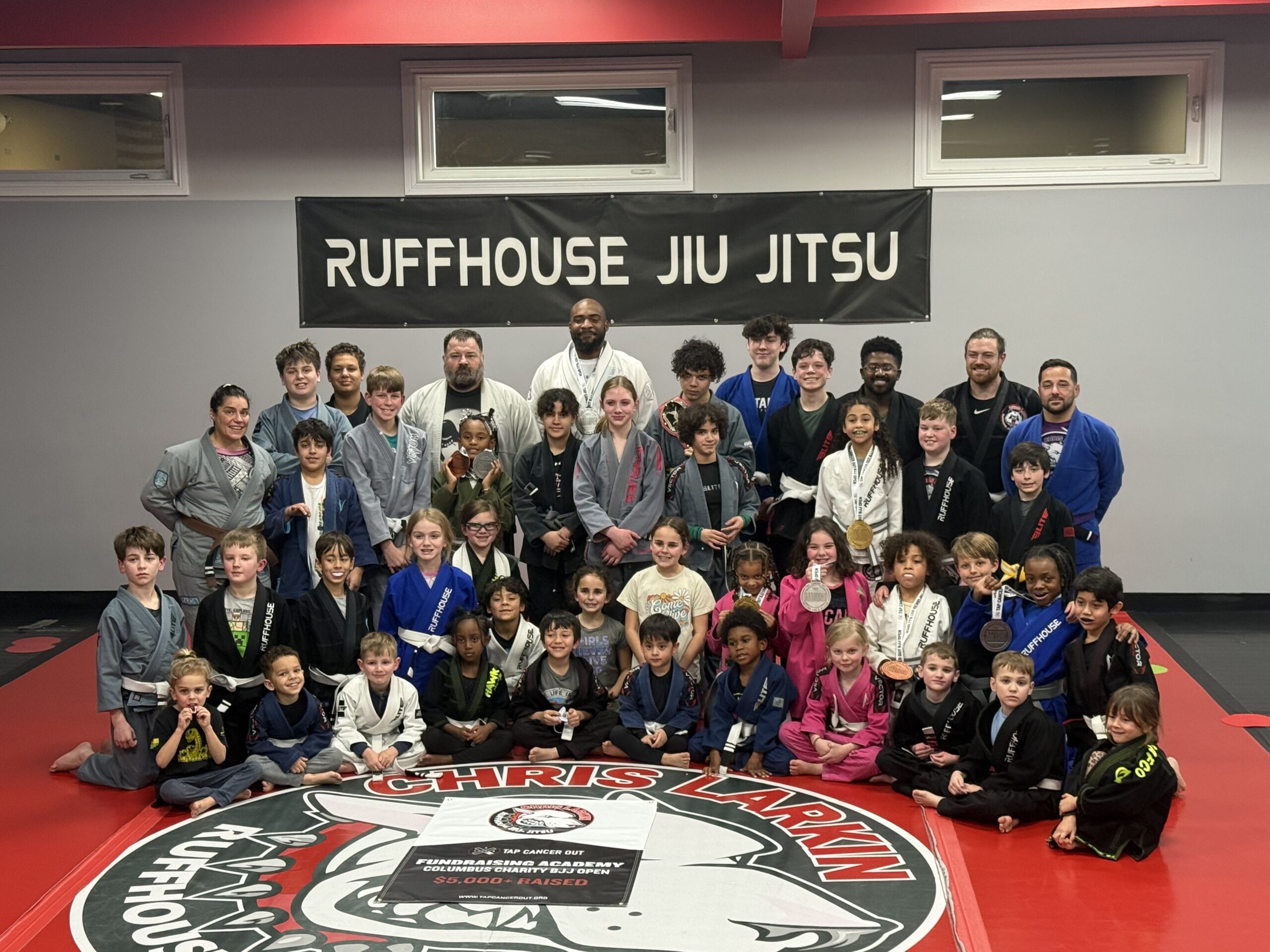 Ruffhouse Jiu-Jitsu students smiling wearing gi uniforms.